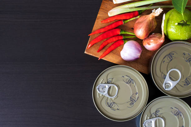 Canned food with fresh vegetables for cooking stock photo