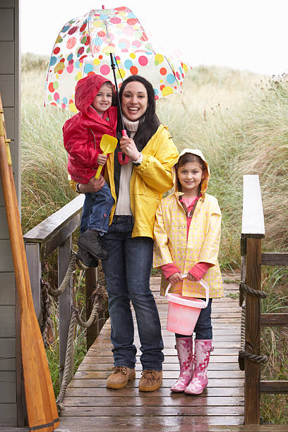 istock Mother with children on rainy beach 122174975