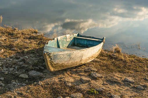 Old boat on the lake, river. At the water. in sunset light
