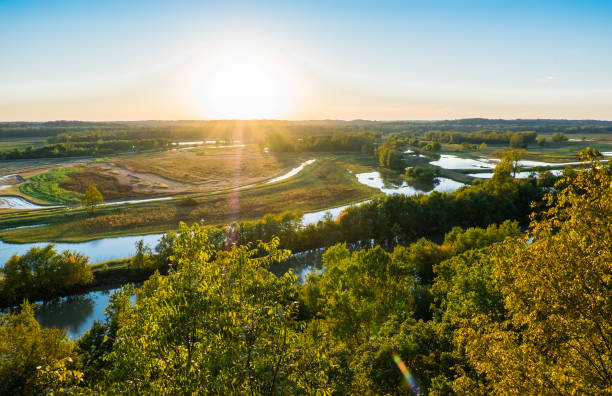 Missouri River floodplane at sunset in fall Beautiful view of Missouri River floodplain at sunset in fall; water in the fields; distant woods and sky in background flood plain photos stock pictures, royalty-free photos & images