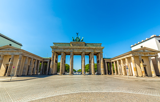 Low angle view of Brandenburg Gate in Berlin, Germany against blue sky with clouds