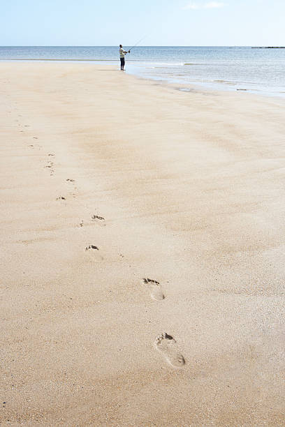 istock Man Walking Along Shore Of Beach 122175137
