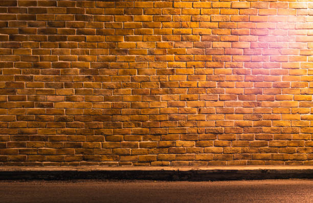 istock Photo of retro brown brickwall with light with copy space. Concept for backdrop or background and banner. 1221751558