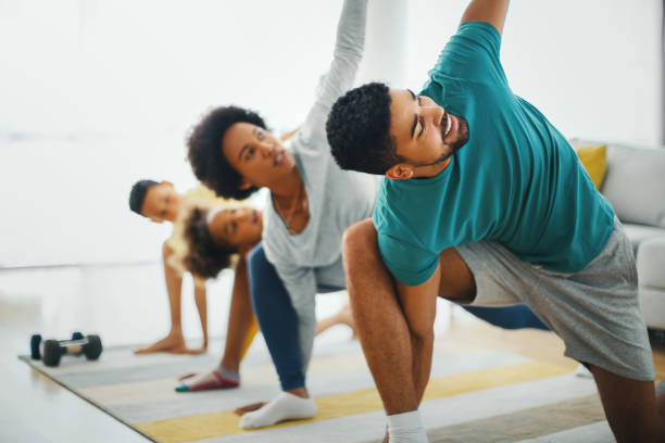istock Family exercising at home. 1221751696