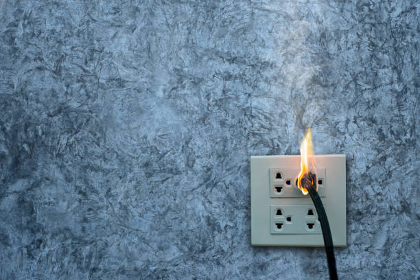 istock On fire electric wire plug Receptacle on the concrete wall exposed concrete background with copy space 1221751741