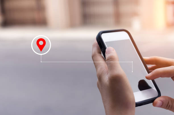 istock Woman hand using smart phone with navigator location point at street background. Technology interenet and travel adventure concept. 1221753075