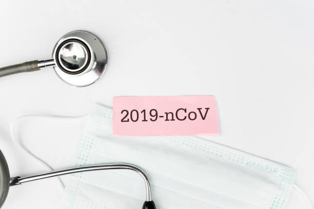 istock Flat lay of nCoV label with stethoscope and mask 1221754317