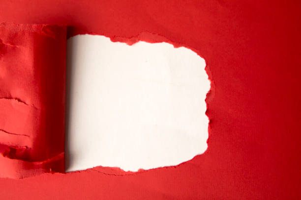 istock Flat layout of a hole from torn red cardboard 1221754348