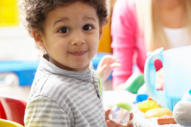 chłopiec bawi się z zabawki w nursery - little boys only playing preschooler child zdjęcia i obrazy z banku zdjęć