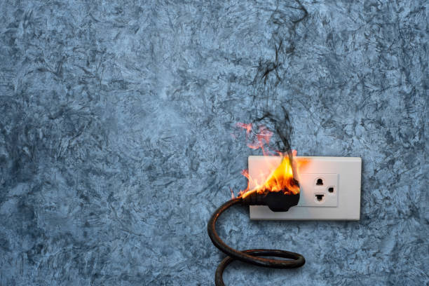 istock On fire electric wire plug Receptacle on the concrete wall exposed concrete background with copy space 1221754692
