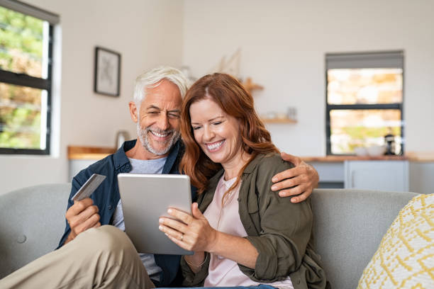 istock Mature couple doing online shopping with digital tablet 1221754832
