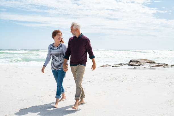 istock Middle aged couple enjoying beach 1221755427