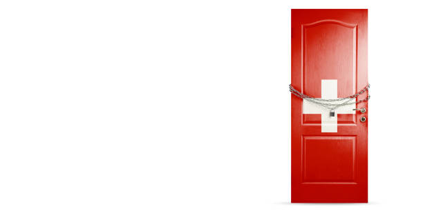 istock Door colored in Switzerland flag, locking with chain. Countries lockdown during coronavirus, COVID spreading 1221756527
