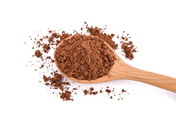 istock Cocoa powder in a wood spoon on white 1221756887