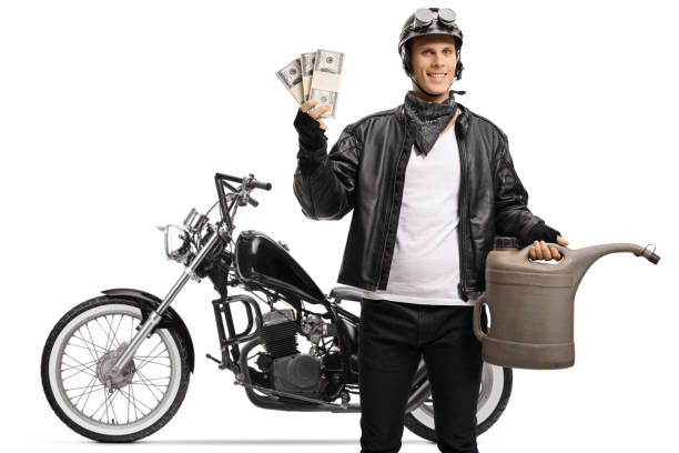 istock Biker with a chopper holding a gas container and money 1221758487