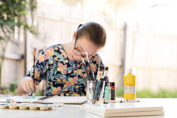 istock Young Girl Doing Art In Back Garden 1221759205