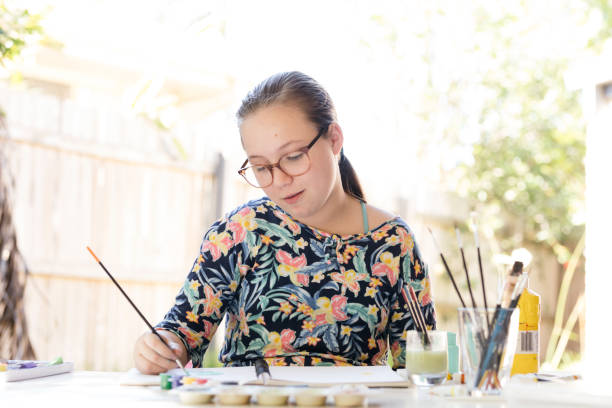 Young Girl Doing Art In Back Garden