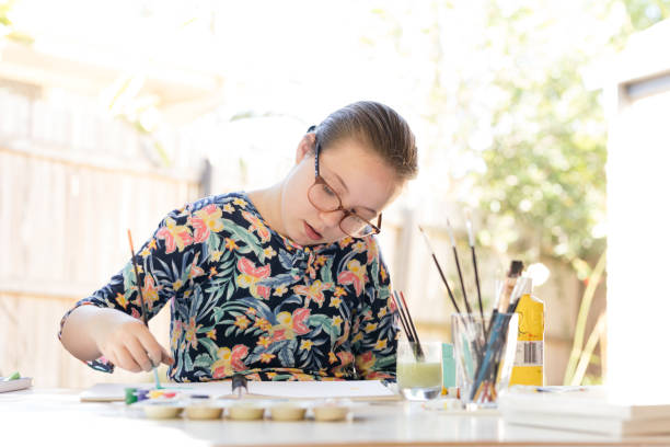 Young Girl Doing Art In Back Garden