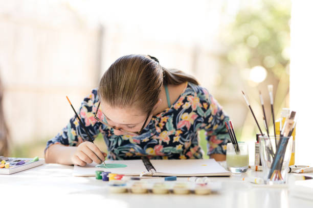 Young Girl Doing Art In Back Garden