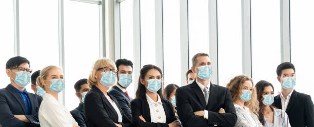 istock Confident business people with face mask protect from Coronavirus or COVID-19. 1221759391