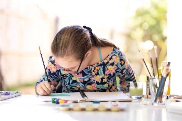 istock Young Girl Doing Art In Back Garden 1221759475