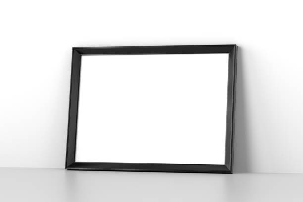 istock Blank wooden picture frame leaning on white wall 1221761217