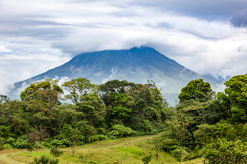 beautiful arenal volcano in the clouds, costa rica.