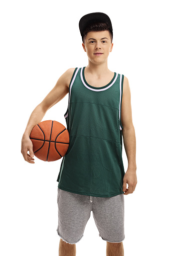 One person of aged 12-13 years old caucasian boys basketball player standing in front of white background and holding basketball - ball and using sports ball