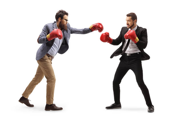 istock Two men in formal clothes fighting with boxing gloves 1221761789