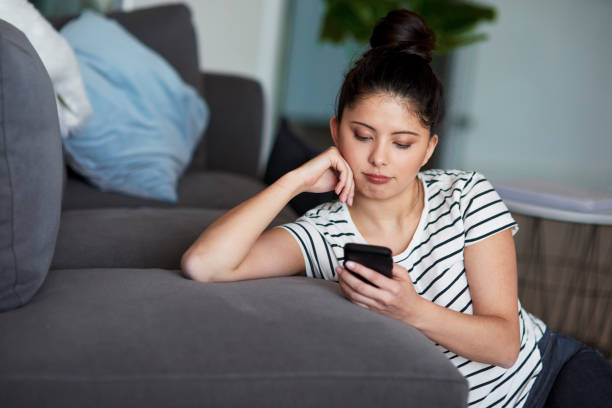 istock Young Asian woman using digital phone at home. 1221763521