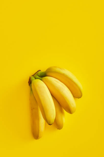istock Bananas on yellow background viewed from above. Top view. Copy space 1221763546