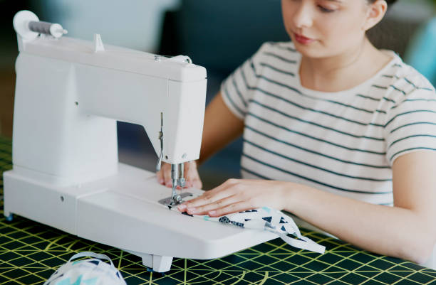 istock Asian woman sewing some pollution masks 1221764187