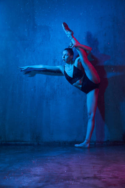 istock Wet ballerina doing split near wall. 1221765491
