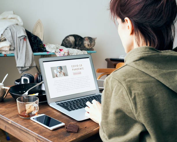 istock Digital addiction, woman in reads or writes articles about coronavirus on Internet 1221768015