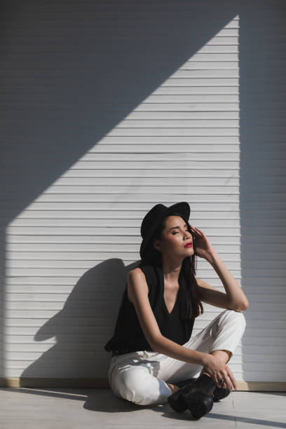 istock Asian woman sitting near window. 1221768056