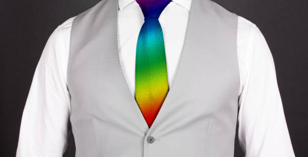 istock Man in a grey suit with rainbow colored tie, close-up 1221768286