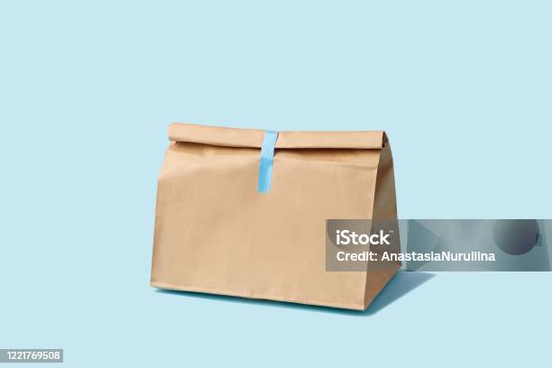 Brown Clear Empty Blank Paper Bag For Food Delivery On Blue Background With Copy Space Packaging Template Mock Up Fast Food Stock Photo - Download Image Now