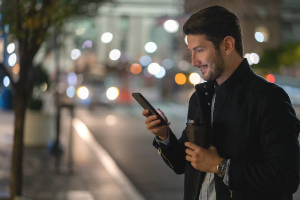 istock Man social networking on his cell phone outdoors at night 1221770034