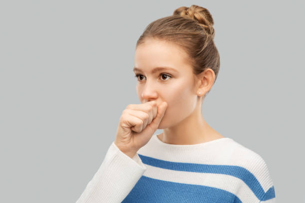 istock sick coughing teenage girl in pullover 1221771357