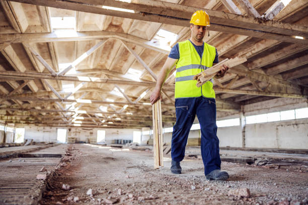 istock Full length of worker relocating joist while walking trough construction site. 1221772991