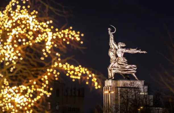 Monument Worker and Collective Farm Girl at VDNH in Moscow and the festive lights of the night city