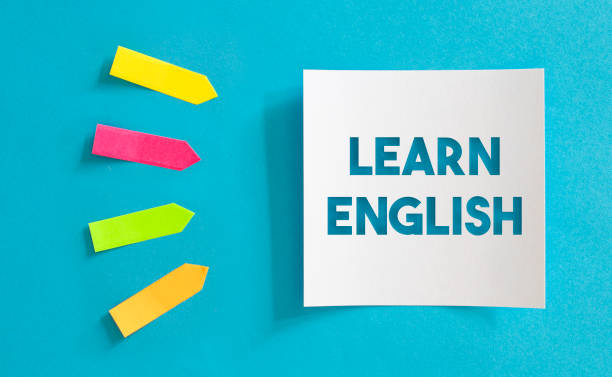 istock Colorful Sticky Notes Papers And White Paper with Learn English Message Over the Blue Paper. 1221774324