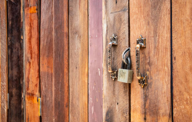 istock Closed old wooden plank door with padlock 1221775045