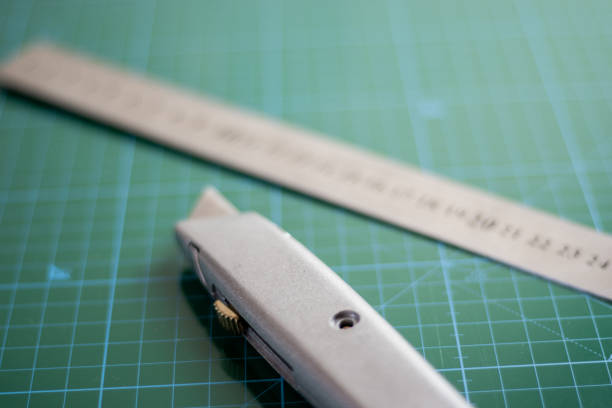 Ruler and utility knife on the green cutting mat