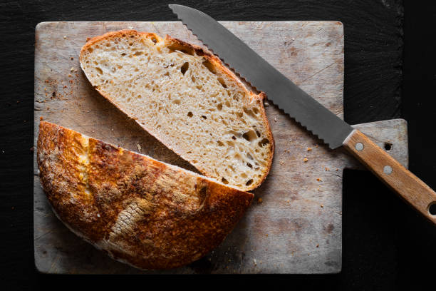 istock Home Cooking Homemade Organic Sourdough bread on black background with copy space 1221780129