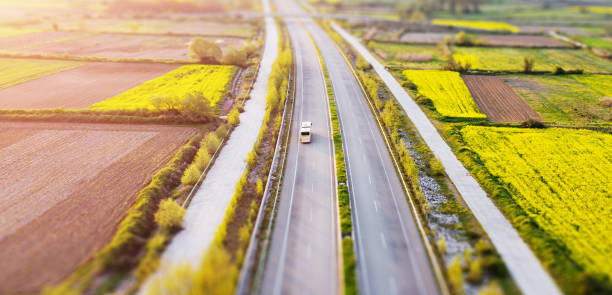 istock Tilt shift miniature effect of landscape with fields and road. 1221781153