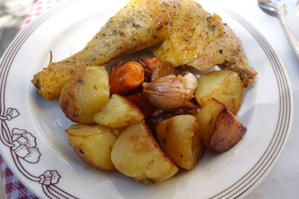 istock Roasted chicken leg in casserole dish served with cooked potatoes 1221781408