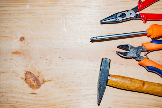Kit of working tools on wooden background