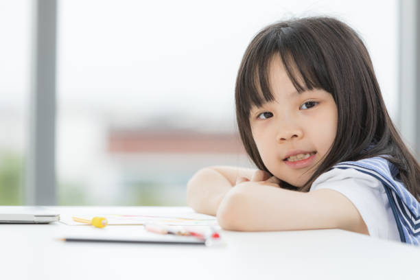 istock Asian girl smiles to camera. 1221782822