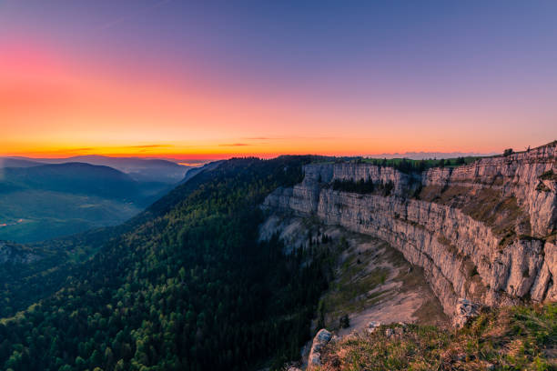 Landscape from Creux du Van the famous rock canyon in Switzerland just before sunrise stock photo